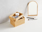 Eine Bambusbox mit Make-up, Wattepads und einem Spiegel.