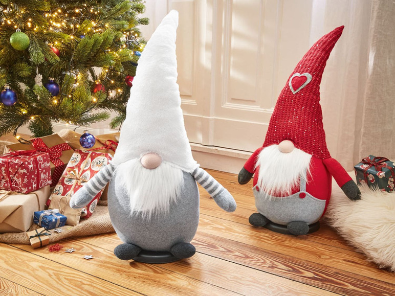 Zwei Plüsch-Weihnachtswichtel mit roten und grauen Mützen.