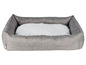 Graue Hundebett mit einem weichen, grauen Kissen.