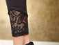 Schwarze Leggings mit Spitze am Saum.