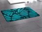 Badematte mit türkisfarbenem Muschelmotiv.
