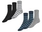 Sechs Paar Socken, darunter schwarze, grau-weiß gestreifte und blau-weiß gestreifte.