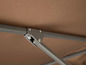 Ein Detail eines braunen Sonnenschirms mit Metallkonstruktion.