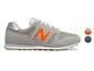 Graue New Balance Sneaker mit orangefarbenem Logo.
