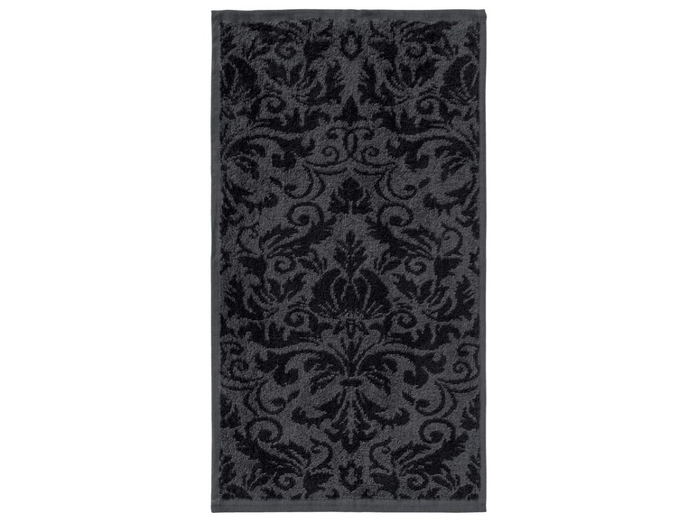 Ein schwarzes Handtuch mit Damastmuster.