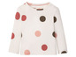 Weißes Langarmshirt für Babys mit rosa und braunen Punkten.
