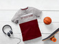Ein grau-rotes T-Shirt mit dem Aufdruck 'Up your game', ein Basketball und ein Skateboard.
