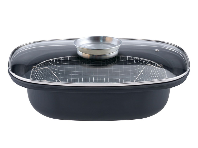 Ein schwarzer Topf mit Glasdeckel, Dampfkorb und einem zusätzlichen Einsatz.