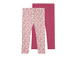 Zwei Leggings für Mädchen: eine rosa mit weißen Blumen und eine einfarbige rosa.