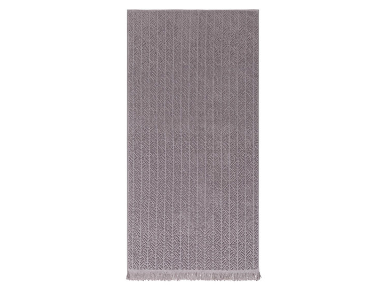 Ein graues Handtuch mit einem gewebten Muster.