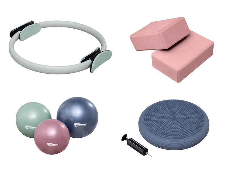 Ein Fitness-Set mit Pilatesring, Yogablöcken, Fitnessbällen und Balance-Disc.
