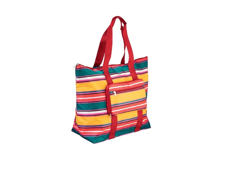 Eine gestreifte Strandtasche mit roten Griffen.