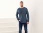 Mann in einem blauen Langarmshirt mit NYC-Aufdruck und blauen Jeans.