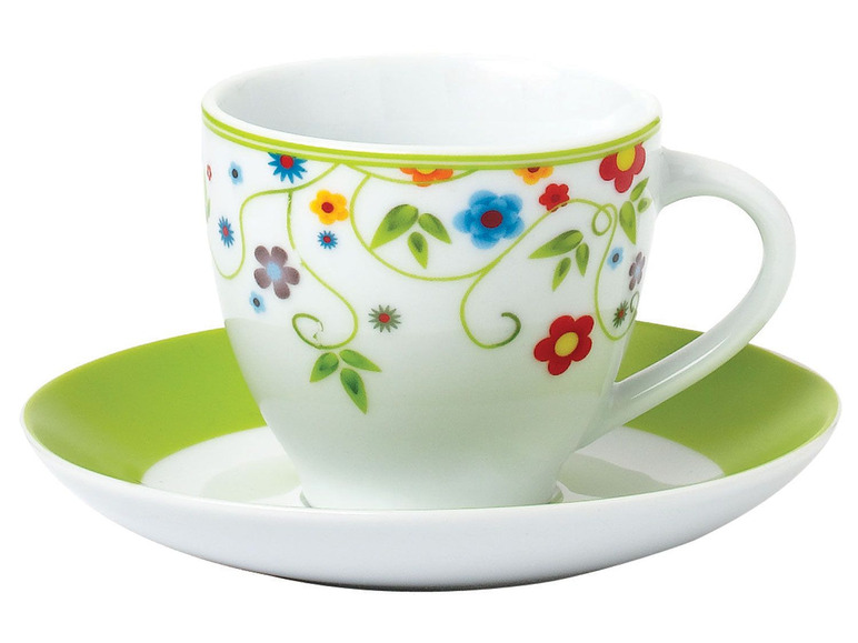 Eine weiße Tasse und Untertasse mit grünem Rand und fröhlichem Blumendesign.