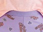 Lilafarbener Pyjama-Hose mit ' ''vibes'-Druck, mit einem rosa Oberteil.