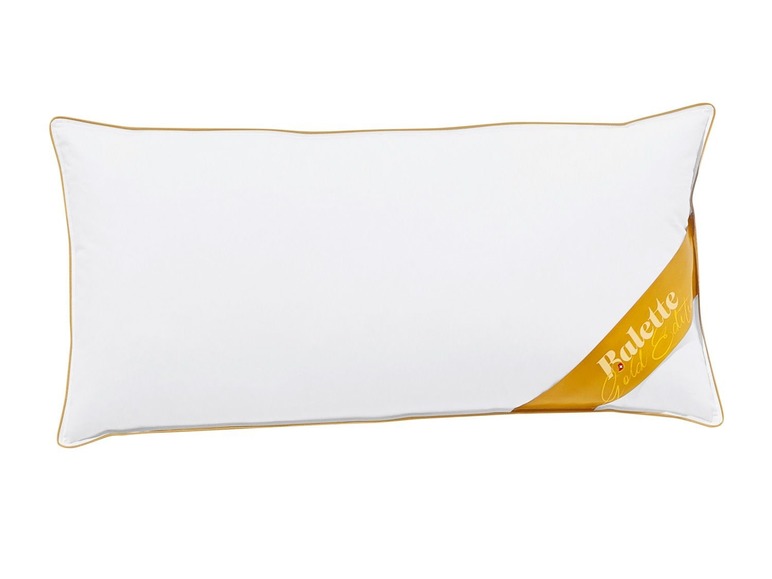 Ein weißes Kissen mit einem gelben Balete Gold Edition Band