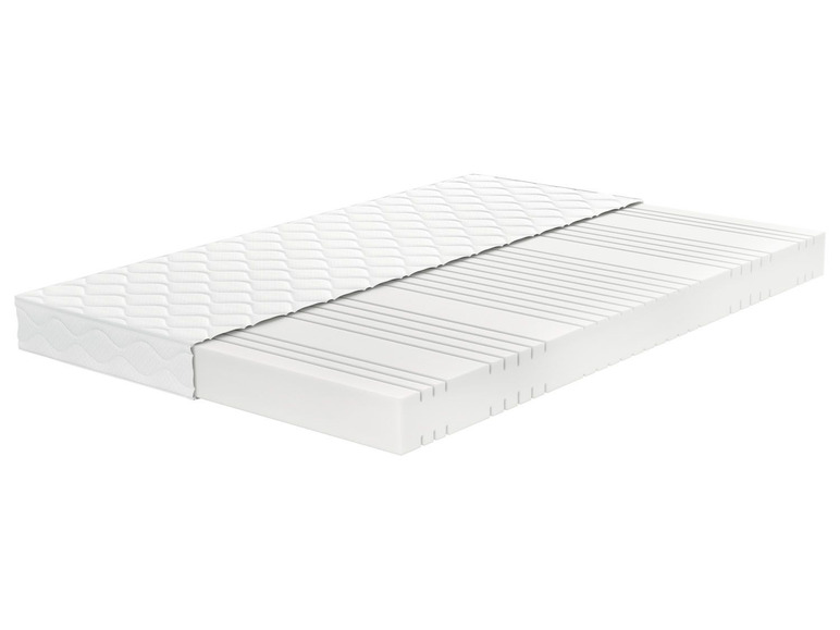 Eine Matratze mit gesteppter Oberseite und einem Kern mit Belüftungsöffnungen.