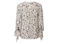 Eine weiße Bluse mit langen Ärmeln und Blumenmuster.