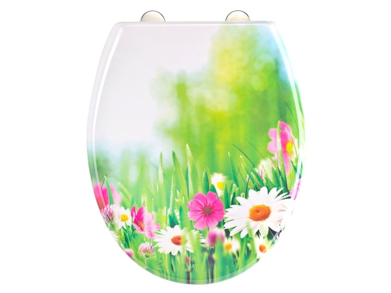 Toilettendeckel mit Blumenmuster auf grünem Gras