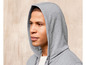 Ein Mann trägt einen grauen Hoodie.