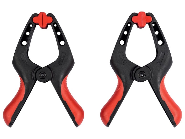 Zwei schwarze Klemmen mit roten Griffen.