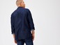 Mann trägt ein dunkelblaues Denimhemd und Jeans.