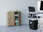 Ein Holzschrank mit Ordnern und einem Aktenvernichter.