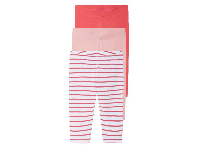 Drei Leggings für Mädchen: rot-weiß gestreift, hellrosa und koralle.