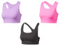 Drei Sport-BHs in verschiedenen Farben: Lila, Pink und Schwarz.