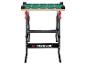 Klappbare Werkbank mit grüner und beiger Platte, mit Raster und Messmarkierungen.