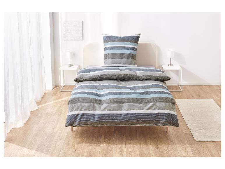 Bett mit gestreifter Bettwäsche.