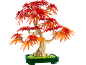 Bonsai-Baum aus Bausteinen mit roten und orangefarbenen Blättern auf grünem Sockel.
