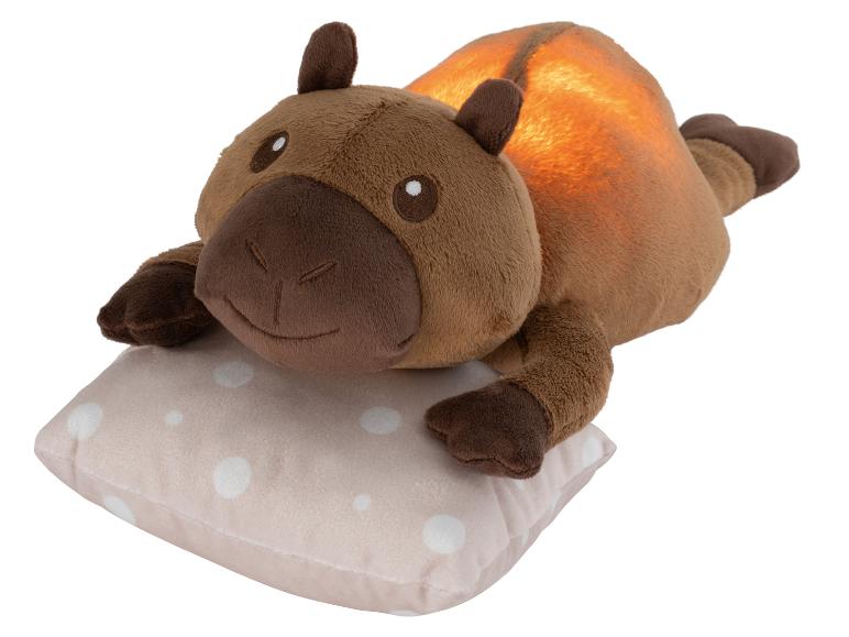 Braunes Plüsch-Capybara-Nachtlicht auf einem gepunkteten Kissen.