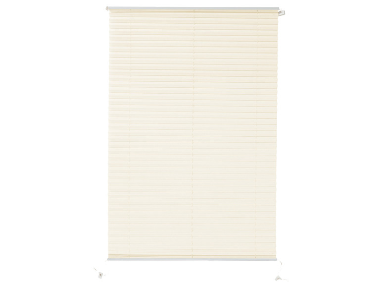 Ein cremefarbener Plissee-Rollladen für ein Fenster.
