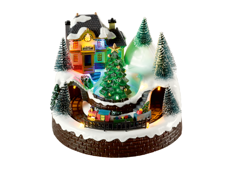Weihnachtsdorf mit Zug, Bahnhof und beleuchteten Bäumen.