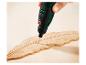 Rotationswerkzeug graviert ein Federdesign in Holz.