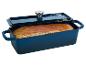 Blaue Gusseisen-Brotform mit einem goldbraunen Brot, Deckel liegt auf.