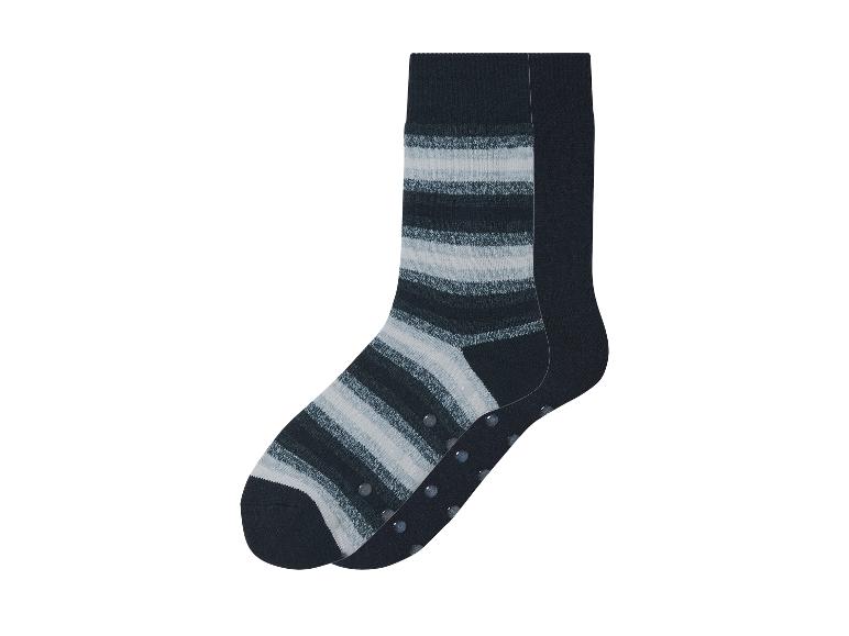 Ein Paar schwarze Socken mit weißen Streifen und Antirutsch-Noppen.