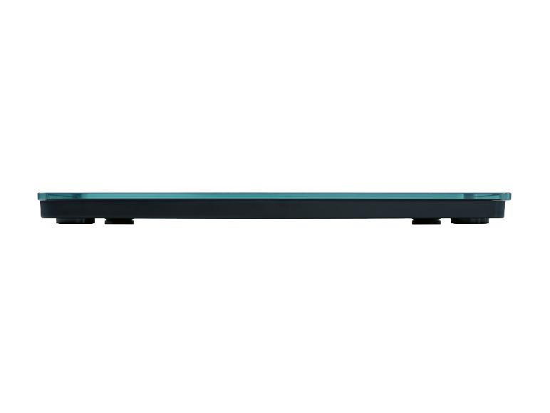 Seitenansicht einer schlanken, schwarzen Badezimmerwaagenplattform mit blauem Glas.