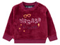 Ein roter Harry Potter Pullover mit dem Schriftzug 'Wizard in training'.