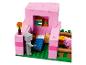 Lego Minecraft Set mit einem rosa Haus, einem Bett, einem Schwein und einer Figur.
