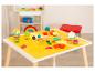 Spieltisch mit bunter Knete, Förmchen und Werkzeugen für Kinder.