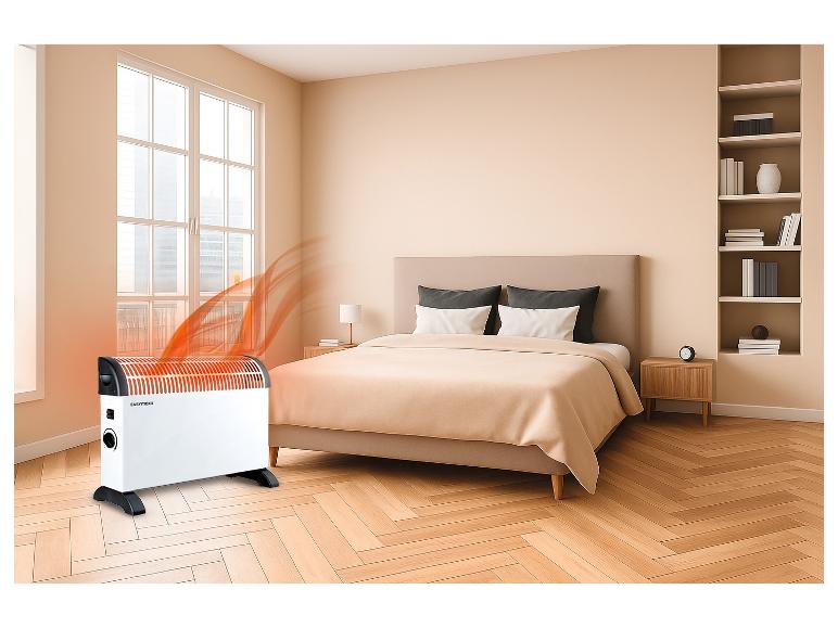 Heizgerät in einem Schlafzimmer mit Bett und Regalen.