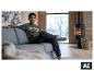 Junge in ESMARA KIDS Thermo-Sweatdenim-Hose entspannt auf dem Sofa am Kamin. [KI-generiertes Bild]