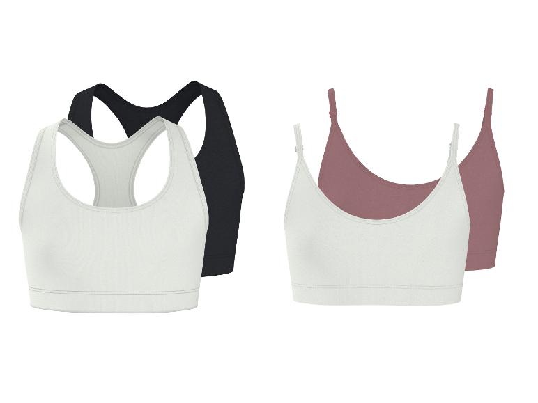 Zwei Sets Damen-Sport-BHs: schwarz-weißer Racerback und weiß-rosafarbener Camisole-Stil.