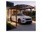 Carport mit weißem Auto vor einem modernen Haus in der Dämmerung.