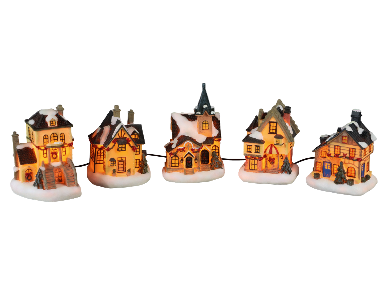 Beleuchtete Weihnachtshäuser mit Schnee auf den Dächern, im Winterdorf-Stil.