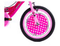 Ein rosa Minnie Mouse Fahrrad mit Punkten.