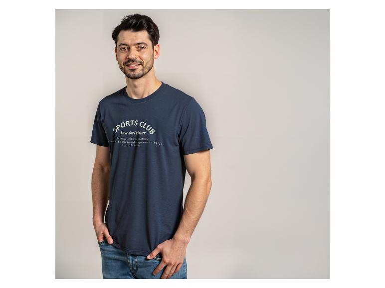 Mann in einem marineblauen T-Shirt mit dem Text „SPORTS CLUB Love for Leisure“ und Jeans.