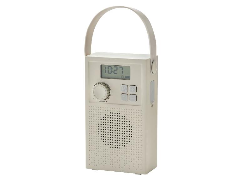 Tragbares beiges Radio mit Digitalanzeige, Tasten und Griff.